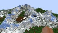 This seed's spawn includes a snowy mountain range complete with some intriguing structures (Image via u/ElegantComplaint7795/Reddit)